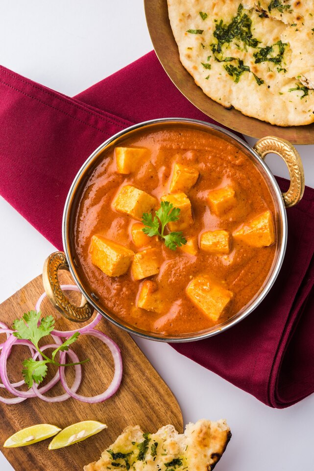 paneer-butter-masala-cheese-cottage-curry-popular-indian-lunch-dinner-menu-served-karahi-with-naan-roti-moody-background-selective-focus-large